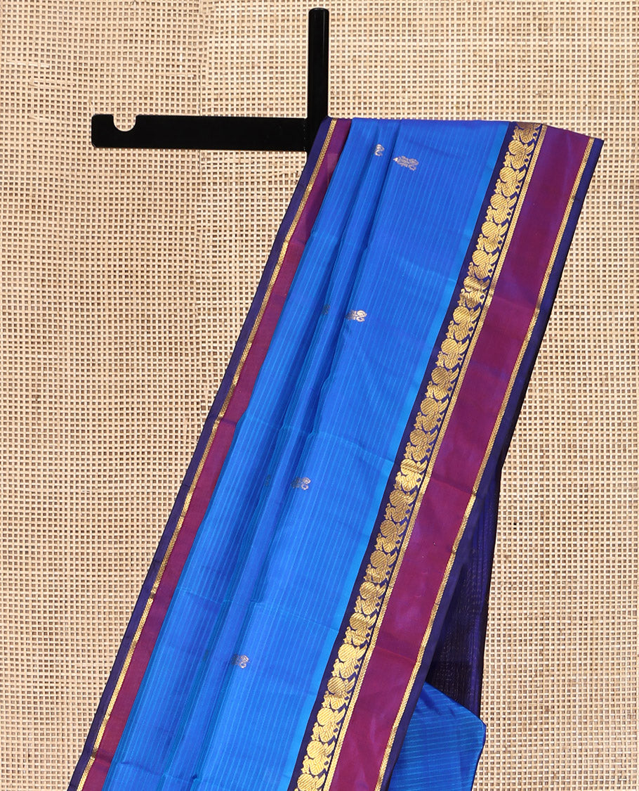 Blue Kanchipuram Silk Saree, Sparsely Sparkled with Vazhaipoo Stripes and Zari Buttas on Its Body, Complemented by Contrast Rettai Pettu Border of Mayil, and Kathir Designs, Zari-Striped Pallu, and Paired with a Contrast Blouse