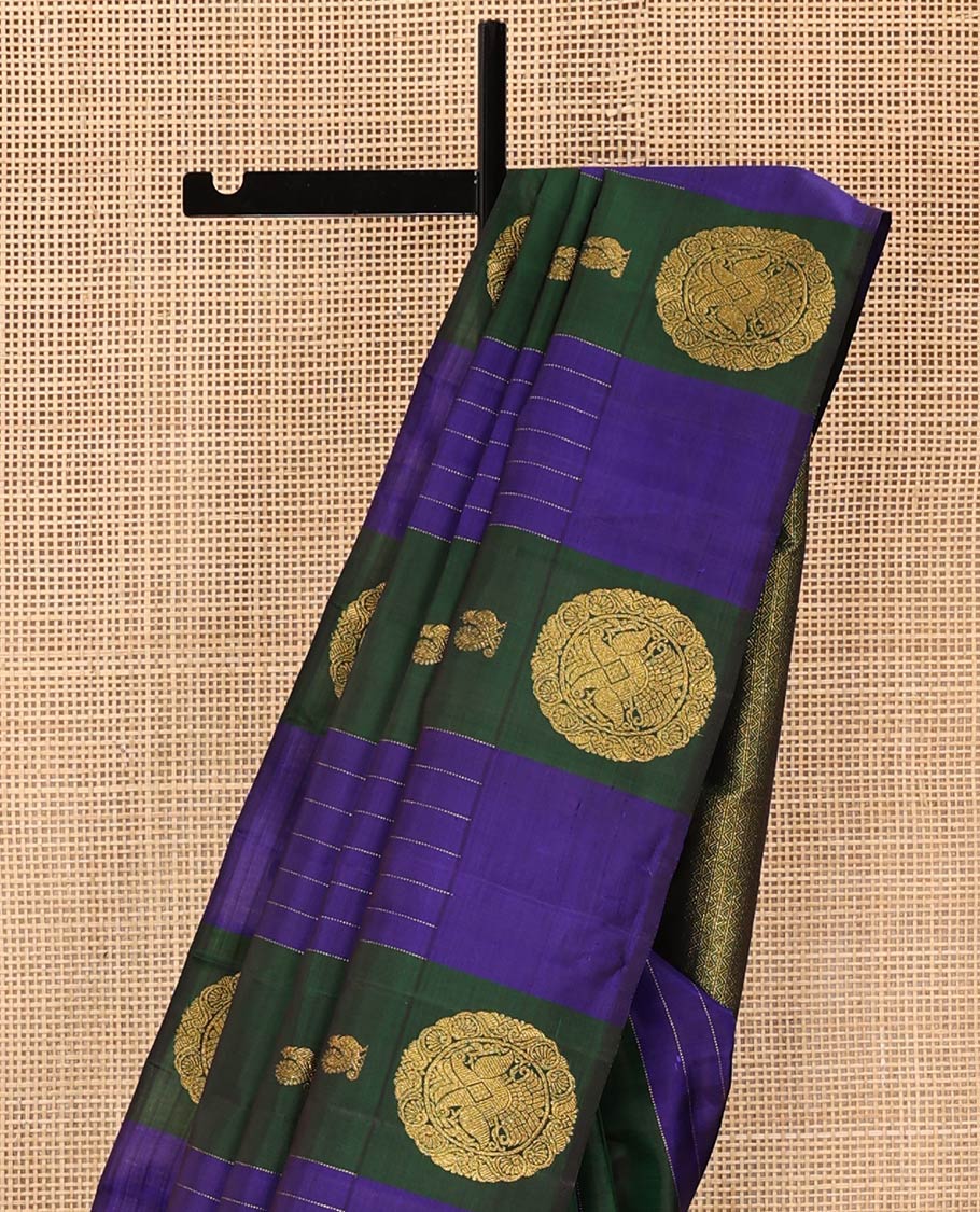 Blue and Green Striped Kanchipuram Silk Saree, Beautifully Bedecked with Muthu Stripes, Mayil, and Round Iruthaipakshi Motifs All Over Its Body, Grand Pallu of Triangle Motifs, and Paired with a Contrast Blouse