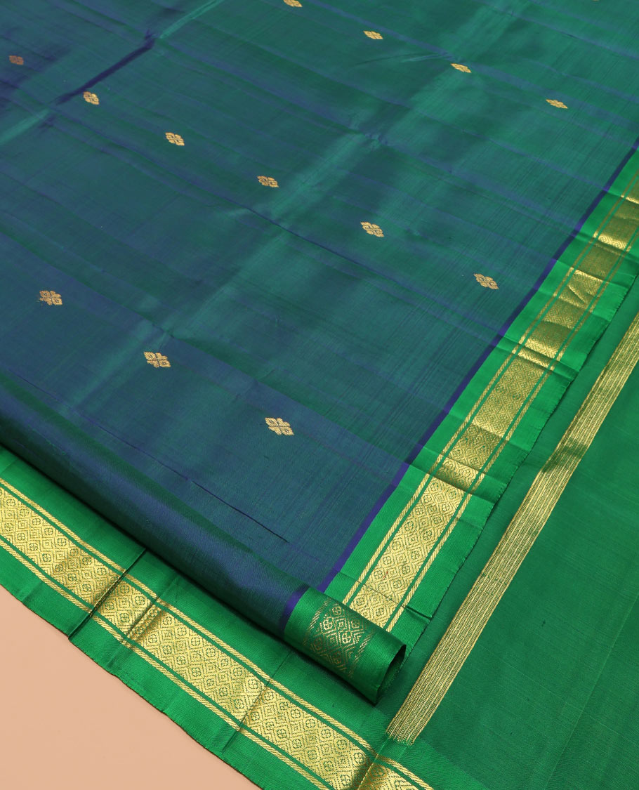 Blue Kanchipuram Silk Saree Featuring Zari Buttas, Complemented by a Contrast One-Sided Border of Banaras, and Jaal Design, Zari Design Pallu, and a No Blouse