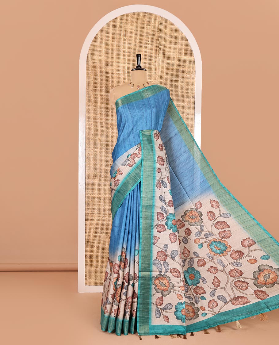 Blue plain fancy tussar saree, contrast floral printed border, floral vine printed pallu, and a contrast plain blouse