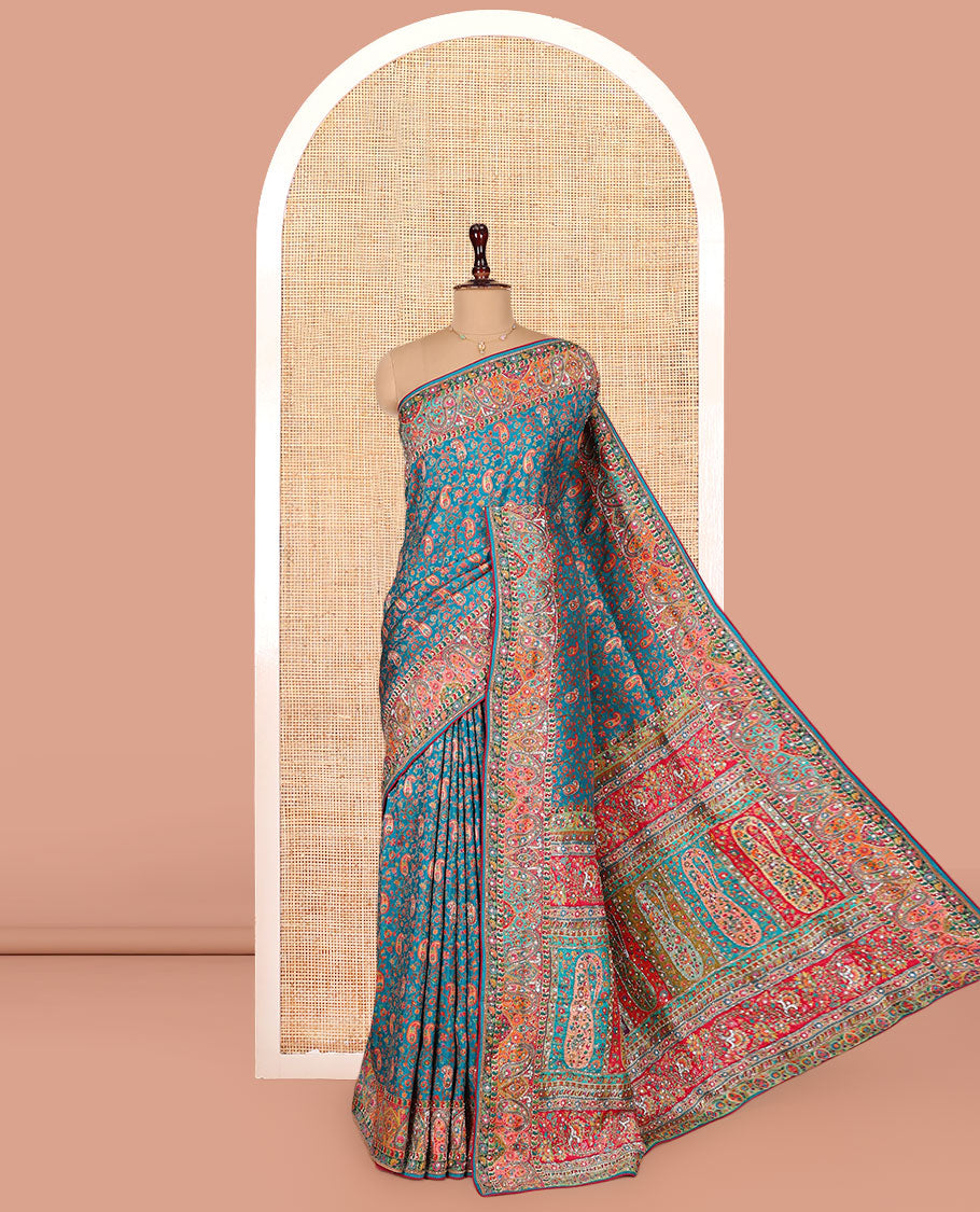 Blue Dola Silk Saree, Opulently Embellished with Colorful Floral-Paisley Design on Its Body, Highlighted by Print and Embroidery Border, Colorfully Decked Up Pallu, and Paired with a Contrast Blouse