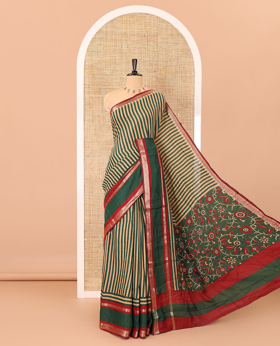 Green vertically striped muslin silk saree, contrast zari rettai pettu border, kalamkari floral vine printed pallu, and a contrast plain blouse