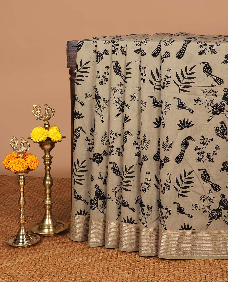 Chikku color birds printed assam silk saree with zari striped border & chit pallu along with butta printed blouse