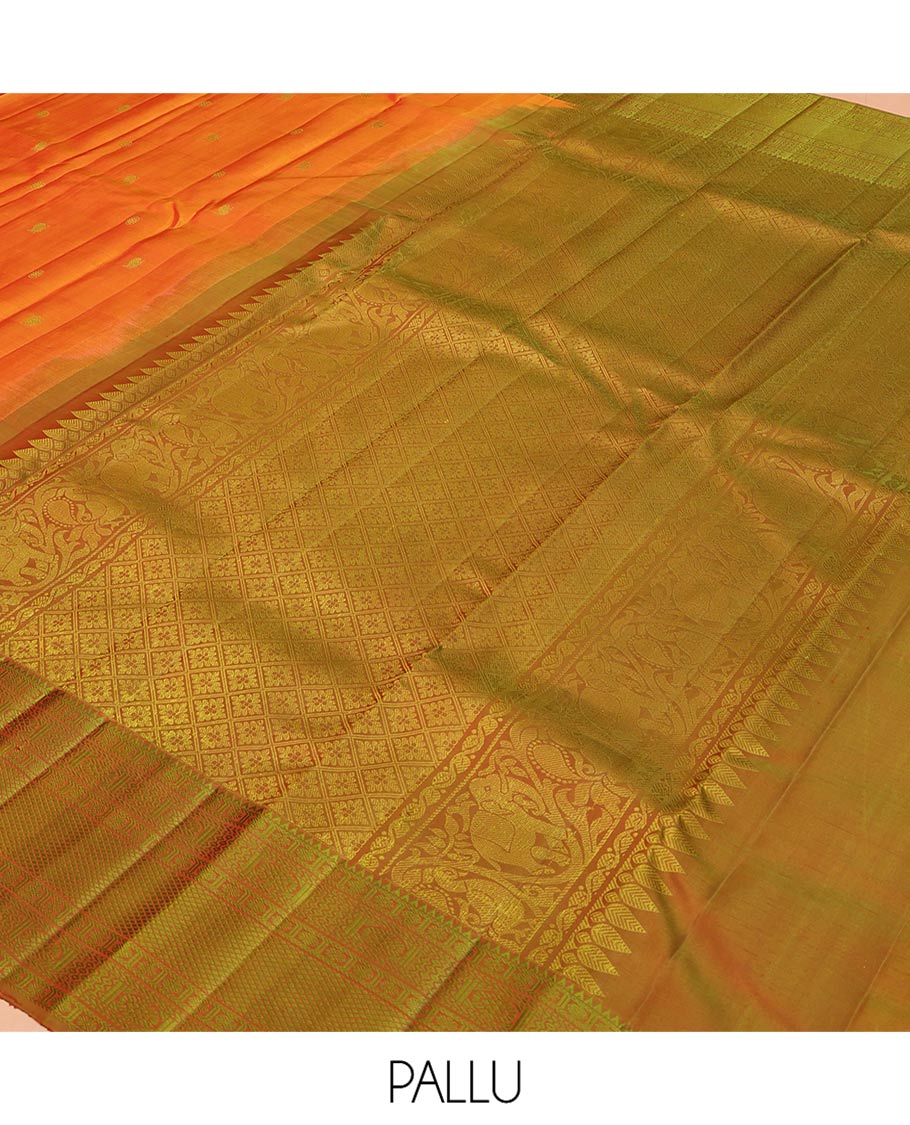 Orange Kanchipuram Silk Saree, Subtly Sparkled with Mayil-Chakram Buttas All Over Its Body, Complemented by a Contrast Border of Rekku, Kamalam, Poun, Chakram, Kuyil Kann, and Then Kuli Kann Designs, Jaal Design Pallu, and Paired with a Contrast Blouse