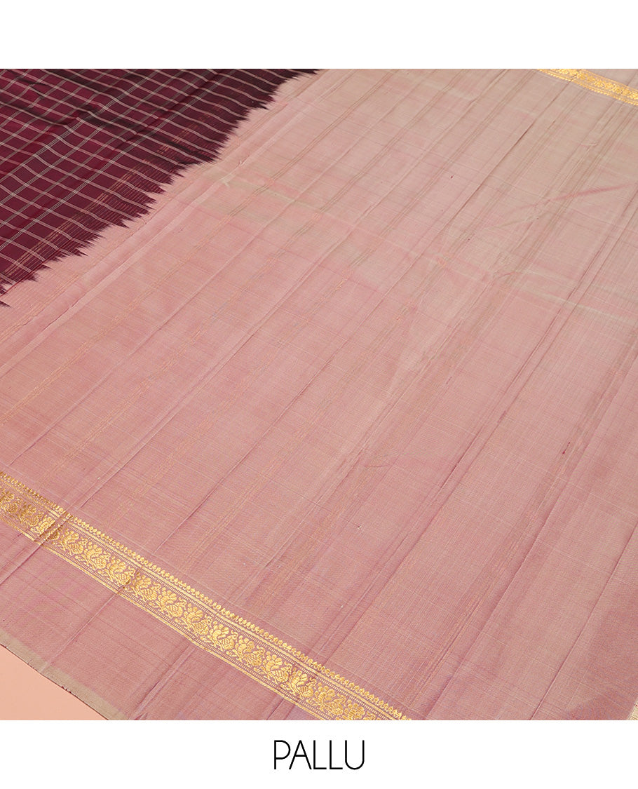 Maroon checked Kanchipuram silk saree, contrast kaal eragina border of thilakam mokku, muthu, and mayil designs, and zari striped pallu