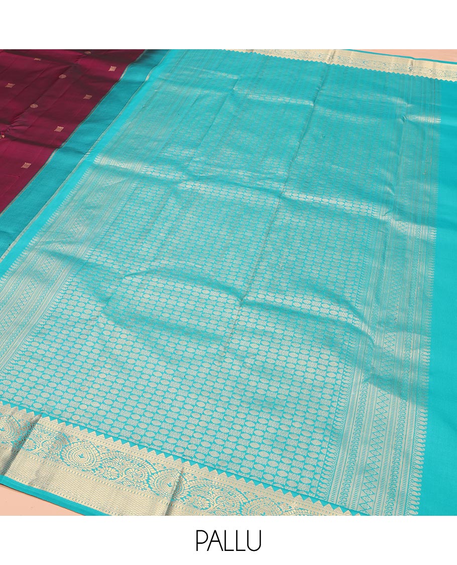 Wine Kanchipuram Silk Saree, Detailed with Zari Buttas on Its Body, Complemented by Contrast Border of Rekku, Muthu, Thilakam, and Mayil Kann Designs, Grandly Woven Pallu, and Paired with a Contrast Blouse