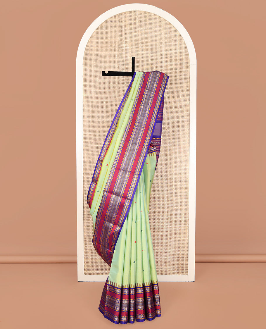 Green Kanchipuram Silk Saree, Beautifully Bedecked with Thread Buttas All Over Its Body, Complemented by a Contrast Border of Thazampoo Rekku, Muthu, Star Vanki, and Rudraksham Designs, Seppu Rekku Pallu, and Paired with a Contrast Blouse