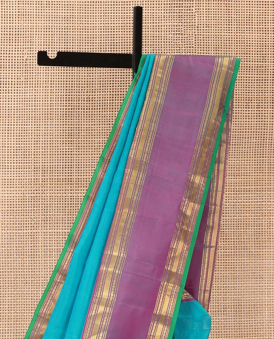 Blue plain Kanchipuram silk saree, contrast rettai pettu border of rekku, banaras, poun and vanki designs, and zari design pallu