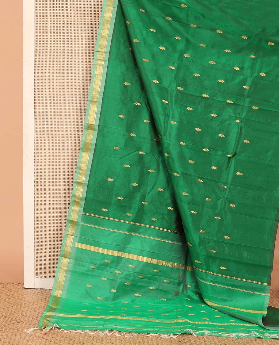 Green Kanchipuram Silk Saree, Beautified with Zari Buttas All Over Its Body, Complemented by Contrast One-Sided Border of Rekku, Banaras, and Mayil Kann Designs, Pallu of Zari Designs, and Comes Without a Blouse