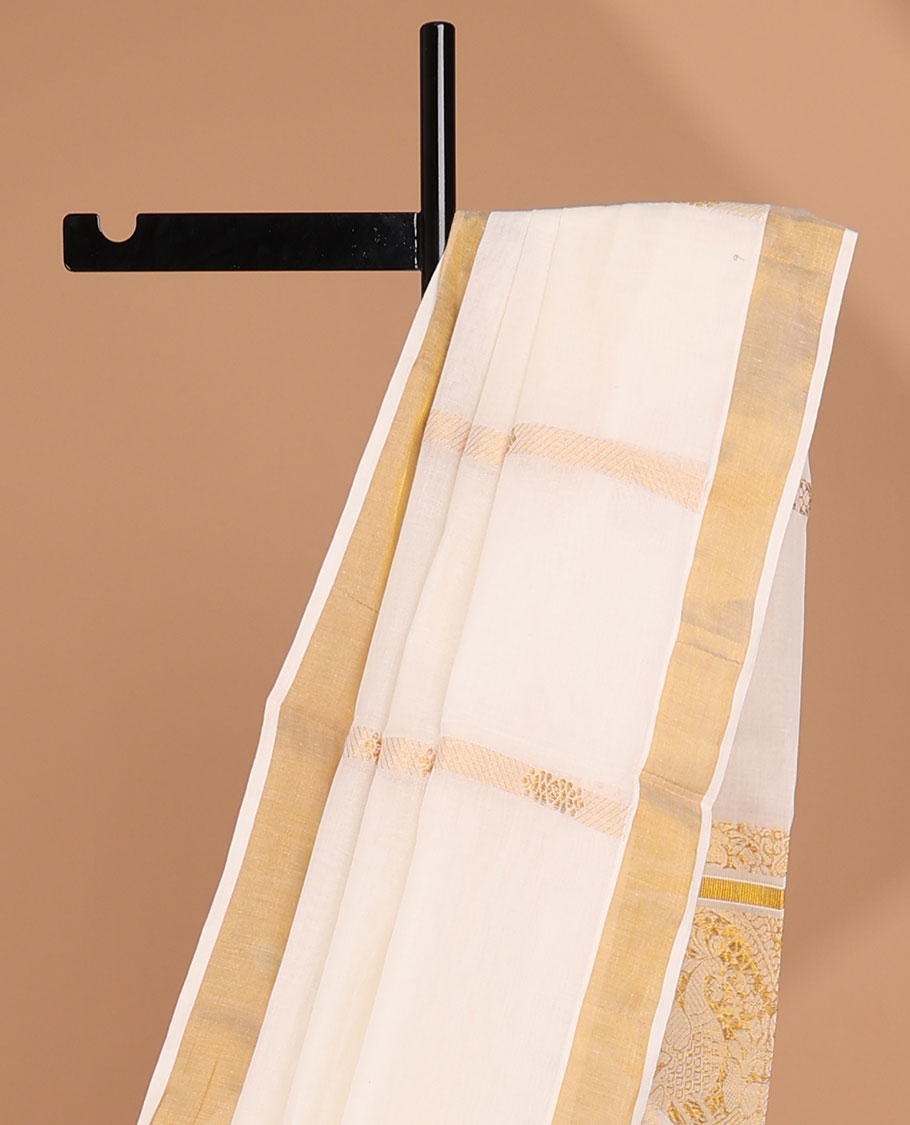 Cream kerala saree with zari stripes, zari border & pallu of peacock designs in zari