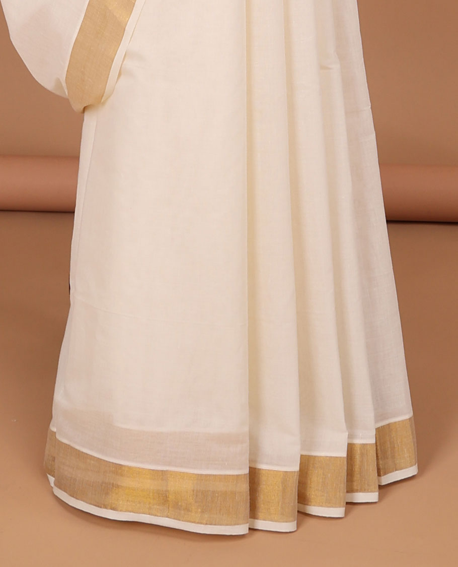Cream kerala saree with zari stripes, zari border & pallu of peacock designs in zari