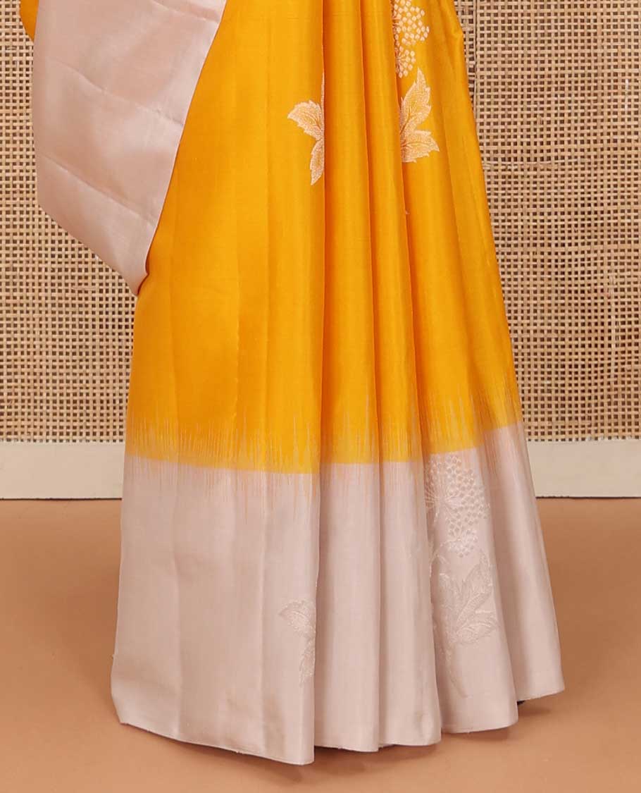 Yellow floral buttas soft silk saree, contrast border of floral buttas, and intricate pallu
