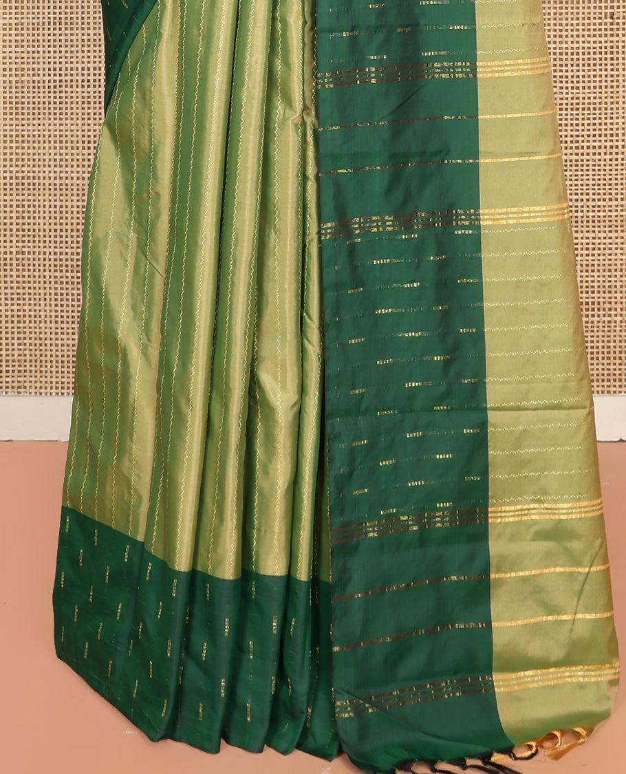 Green Aarani Silk Saree, Lightly Embellished with Zig-Zag Stripes All Over Its Body, Complemented by a Contrast Zari Buttas Border, Pallu of Stripes, and Paired with a Matching Blouse