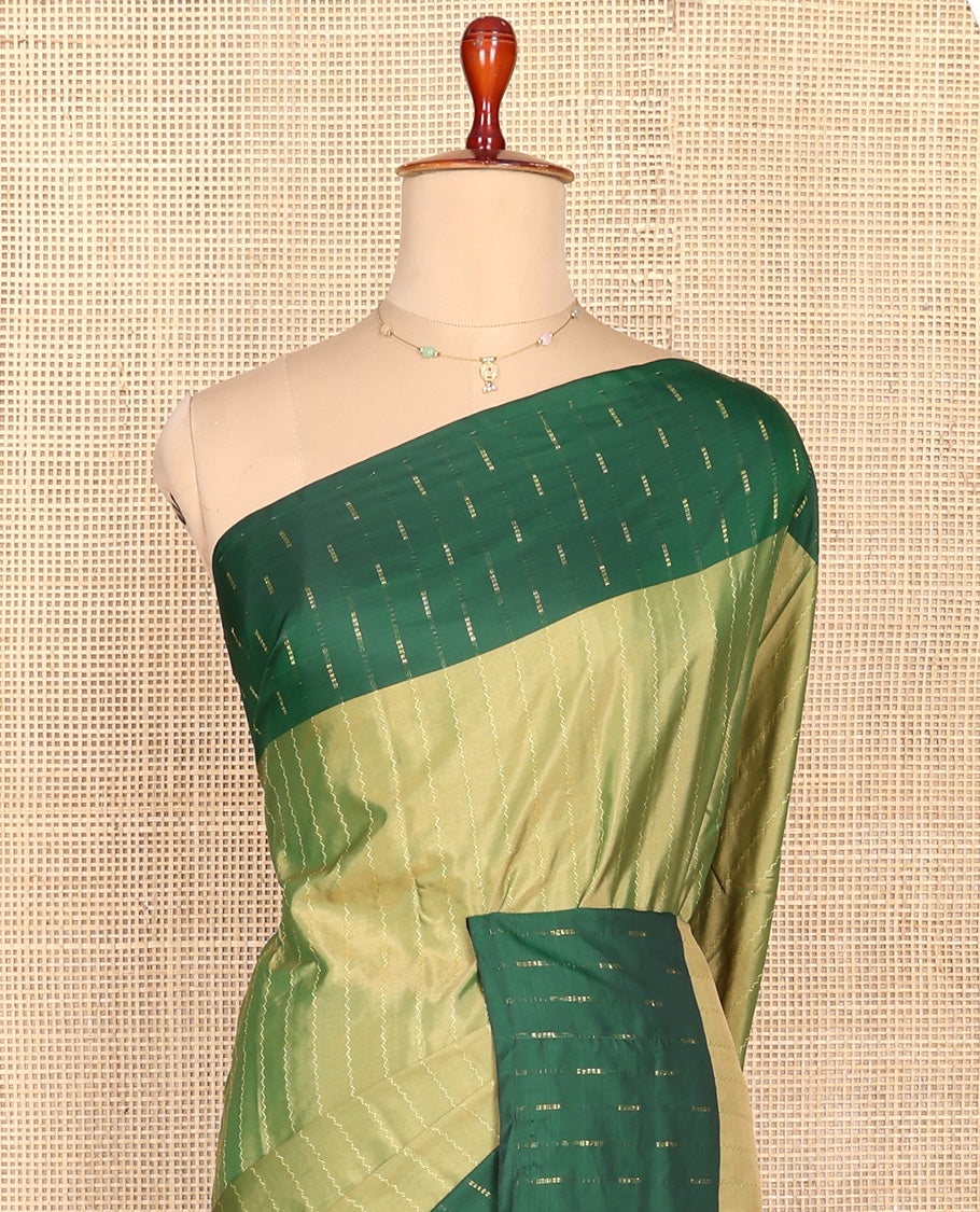 Green Aarani Silk Saree, Lightly Embellished with Zig-Zag Stripes All Over Its Body, Complemented by a Contrast Zari Buttas Border, Pallu of Stripes, and Paired with a Matching Blouse