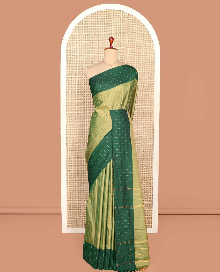 Green Aarani Silk Saree, Lightly Embellished with Zig-Zag Stripes All Over Its Body, Complemented by a Contrast Zari Buttas Border, Pallu of Stripes, and Paired with a Matching Blouse
