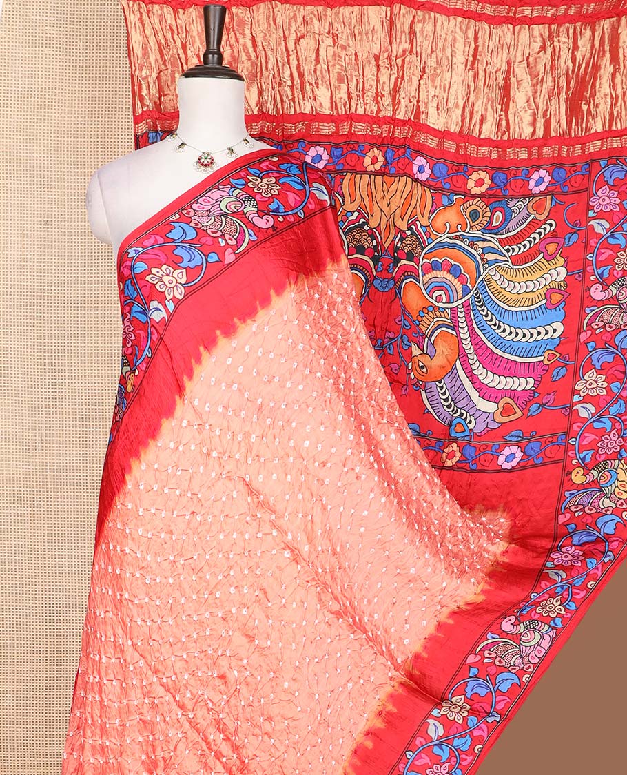 Peach bandhani dotted bandhani silk saree, contrast kalamkari floral vine and peacocks printed border of peacock printed pallu