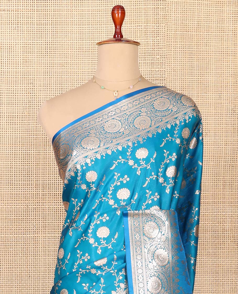 Blue Semi-Banaras Saree, Majestically Detailed with Floral Jaal Jacquard on Its Body, Highlighted by a Floral Creeper Design Border, Intricately Designed Zari Pallu, and Paired with a Matching Blouse