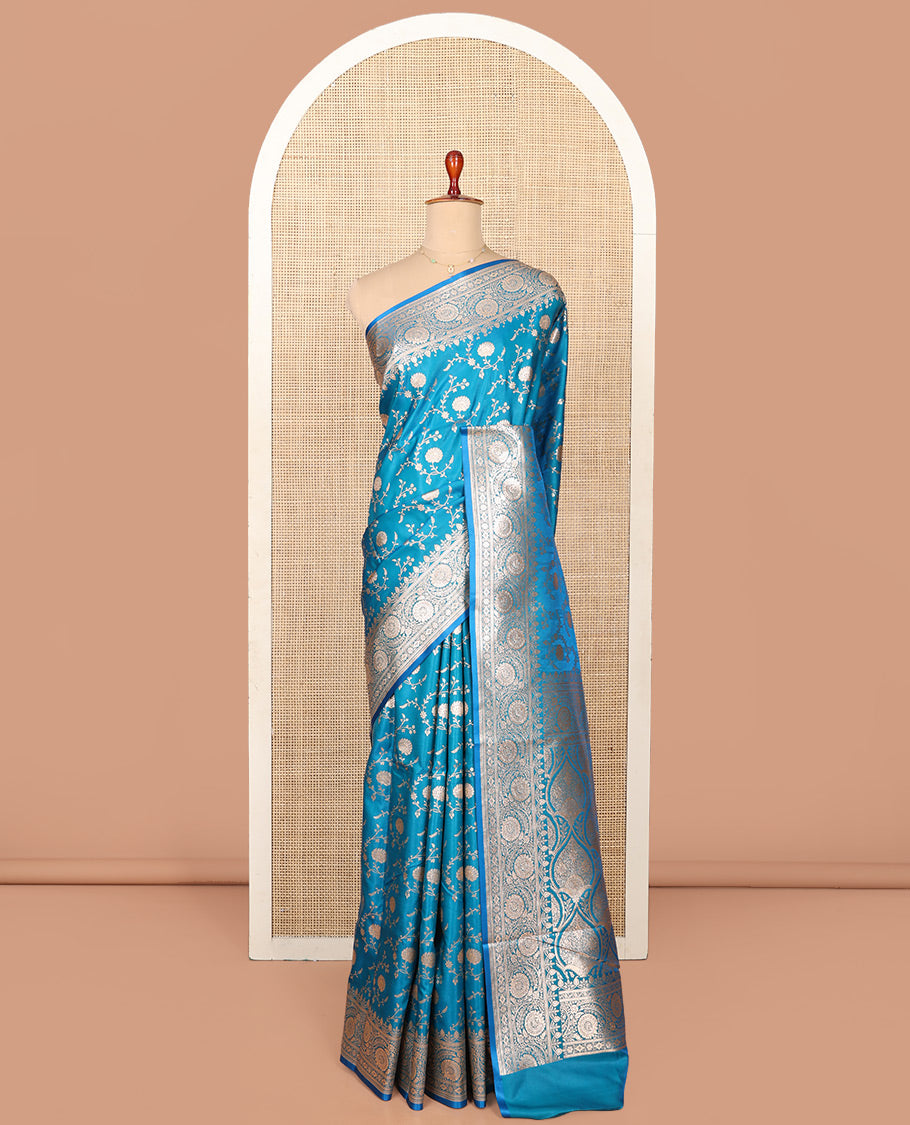 Blue Semi-Banaras Saree, Majestically Detailed with Floral Jaal Jacquard on Its Body, Highlighted by a Floral Creeper Design Border, Intricately Designed Zari Pallu, and Paired with a Matching Blouse