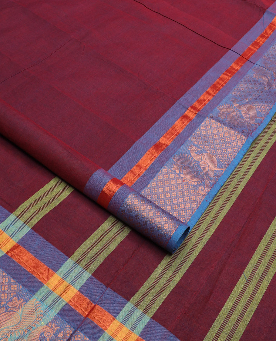 Maroon plain design nine-yard cotton saree, contrast traditional zari border, and pallu of stripes