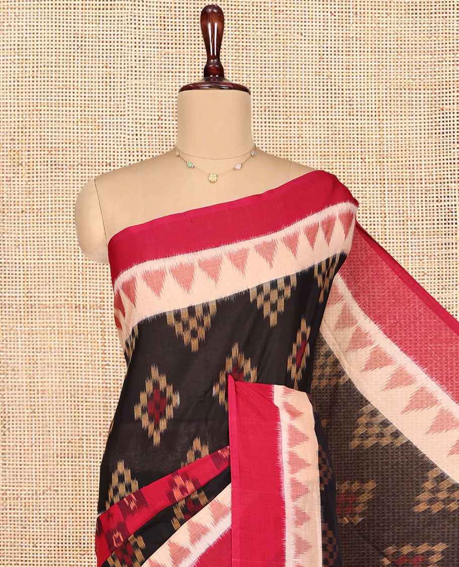 Black Ikkat Cotton Saree, Ornamented with Ikkat-style Buttas All Over Its Body, Complemented by a Contrast Temple Border, Pallu of Geometric Patterns, and Paired with a Contrast Blouse