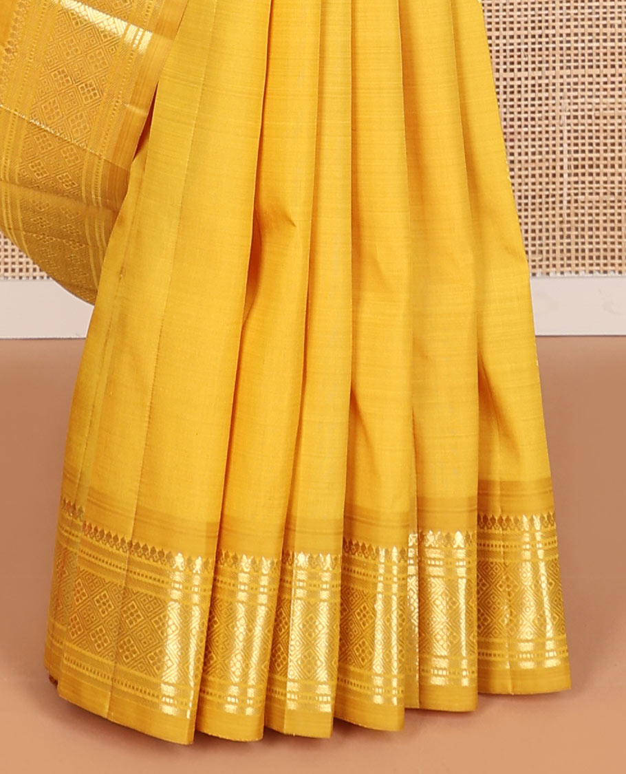Mustard buttas kancheepuram silk saree with contrast border of thilakam mokku, banaras, muthu,checked design & zari design pallu