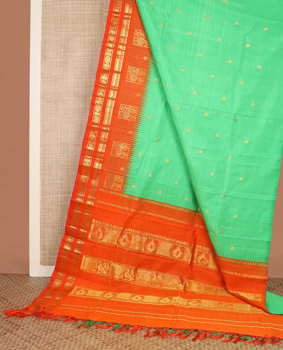 Green zari buttas silk saree, contrast one-sided temple rettai pettu border of salangai,banaras,rettai neli & chakram & intricate pallu