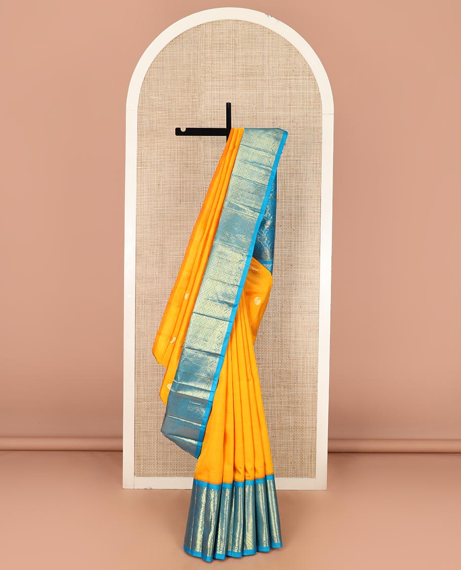 Yellow Kanchipuram Silk Saree Meticulously Woven with Zari Buttas All Over Its Body, Complemented by a Contrast One-Sided Korvai Border of Jaal Designs, Richly Woven Pallu of Intricate Motifs in Zari, and Comes Without a Blouse