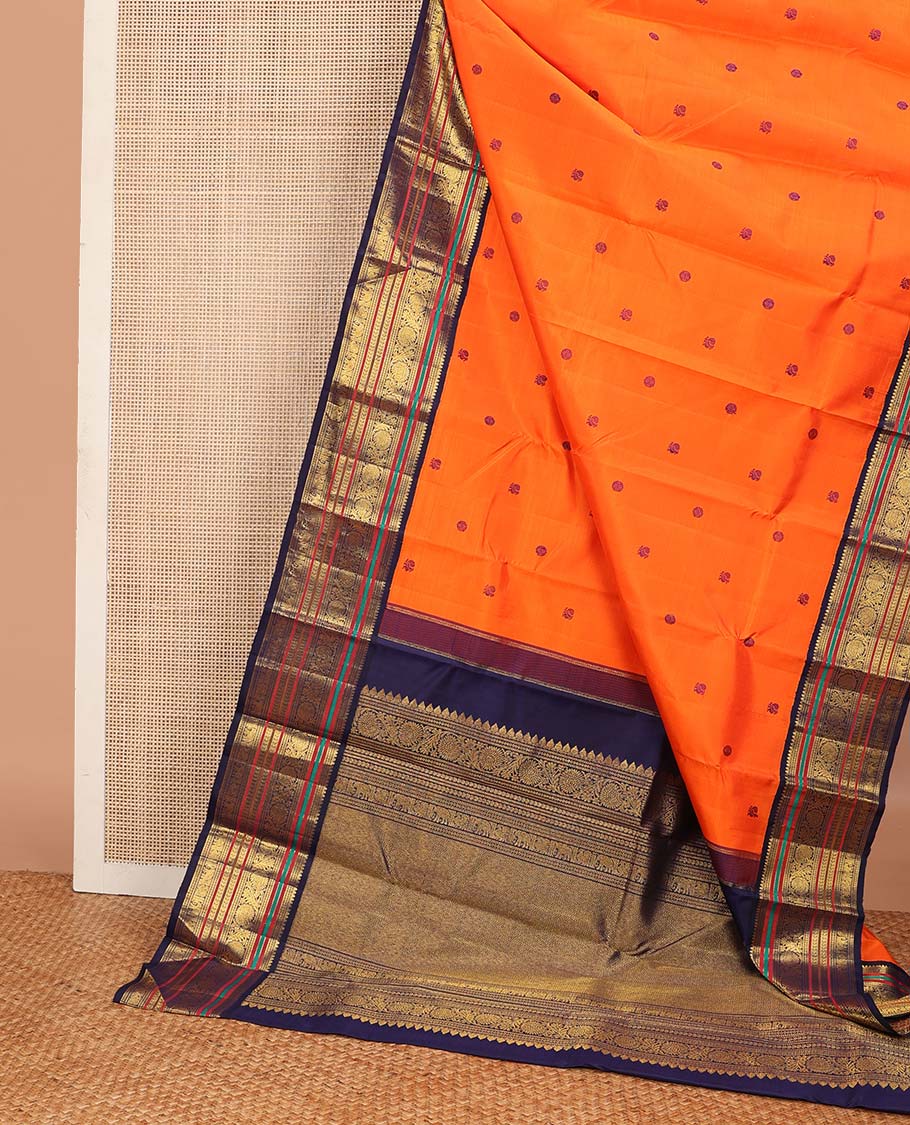 Orange annam chakram buttas Kanchipuram korvai silk saree, contrast rettai pettu korvai border of rekku, banaras, muthu, and chakram designs, and poun design steeped pallu