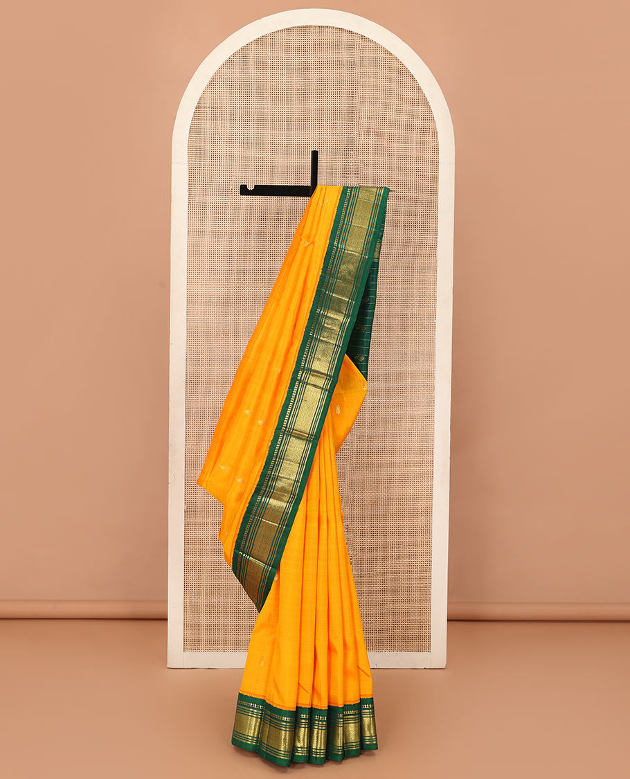 Yellow zari buttas Kanchipuram silk saree, contrast one-sided korvai border of panner, sombu, banaras, muthu, and mayil kann and zari design pallu