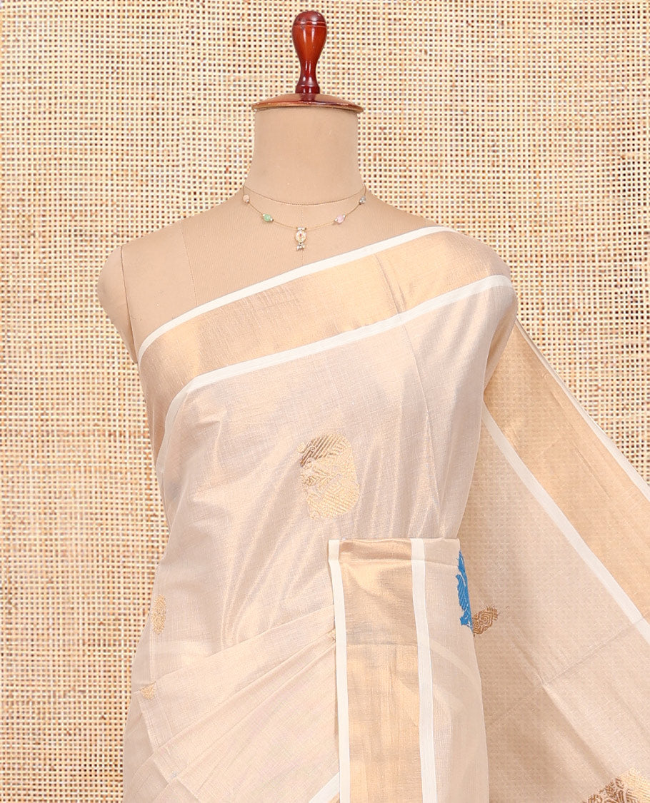 Cream Kerala Cotton Saree, Bedecked with Thread and Zari Buttas All Over Its Body, a Zari Bavanji Border, Pallu of Intricate Designs, and Paired with a Matching Blouse