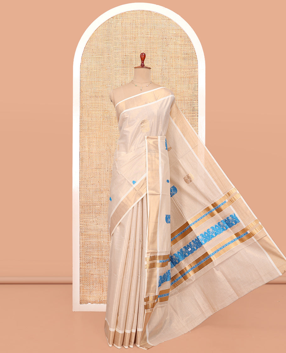 Cream Kerala Cotton Saree, Bedecked with Thread and Zari Buttas All Over Its Body, a Zari Bavanji Border, Pallu of Intricate Designs, and Paired with a Matching Blouse