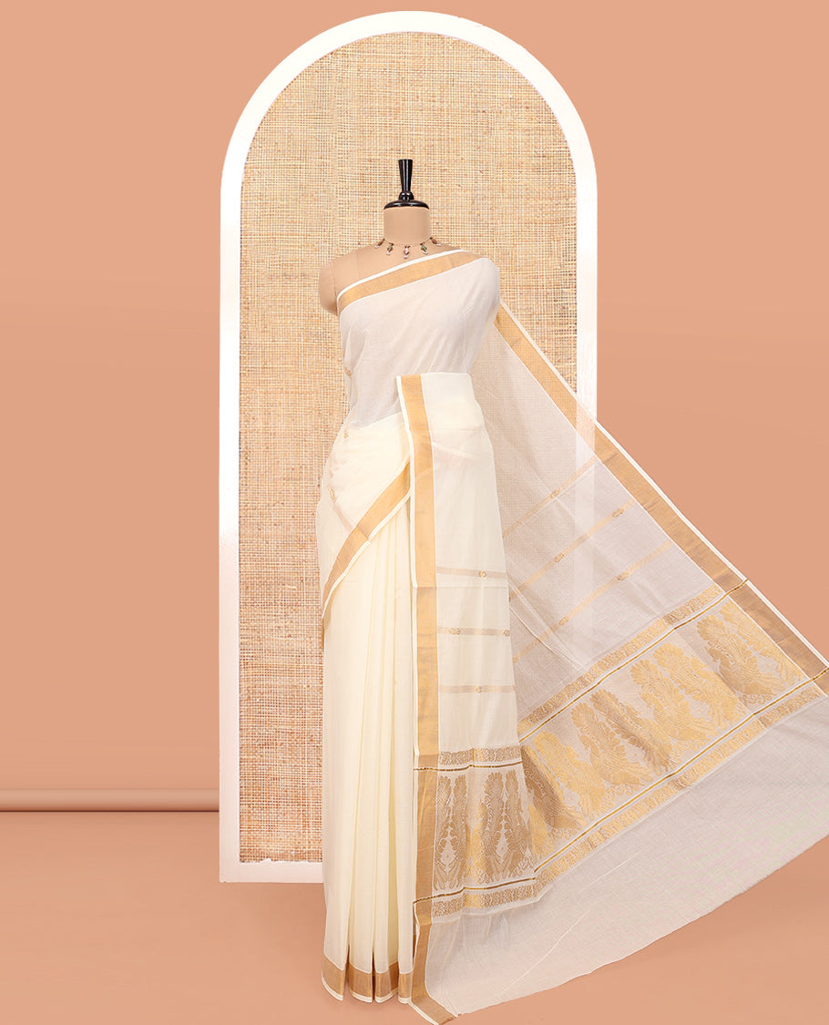Cream Kerala Cotton Saree, Enriched with Zari Stripes All Over Its Body, a Subtle Bavanji Border, Pallu Features Peacock Designs, and Paired with a Matching Blouse
