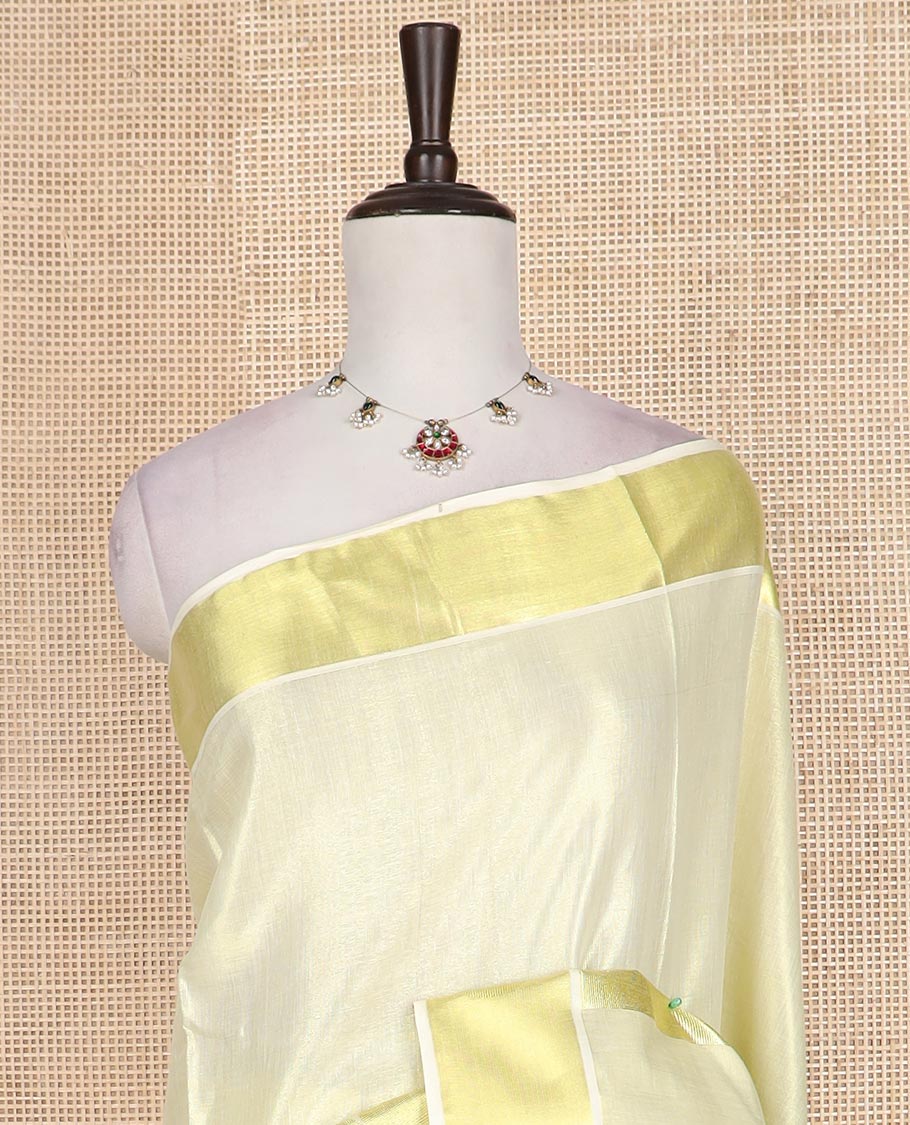 Cream plain Kerala cotton saree, zari border of temple, and zari paisley motifs, and zari striped pallu