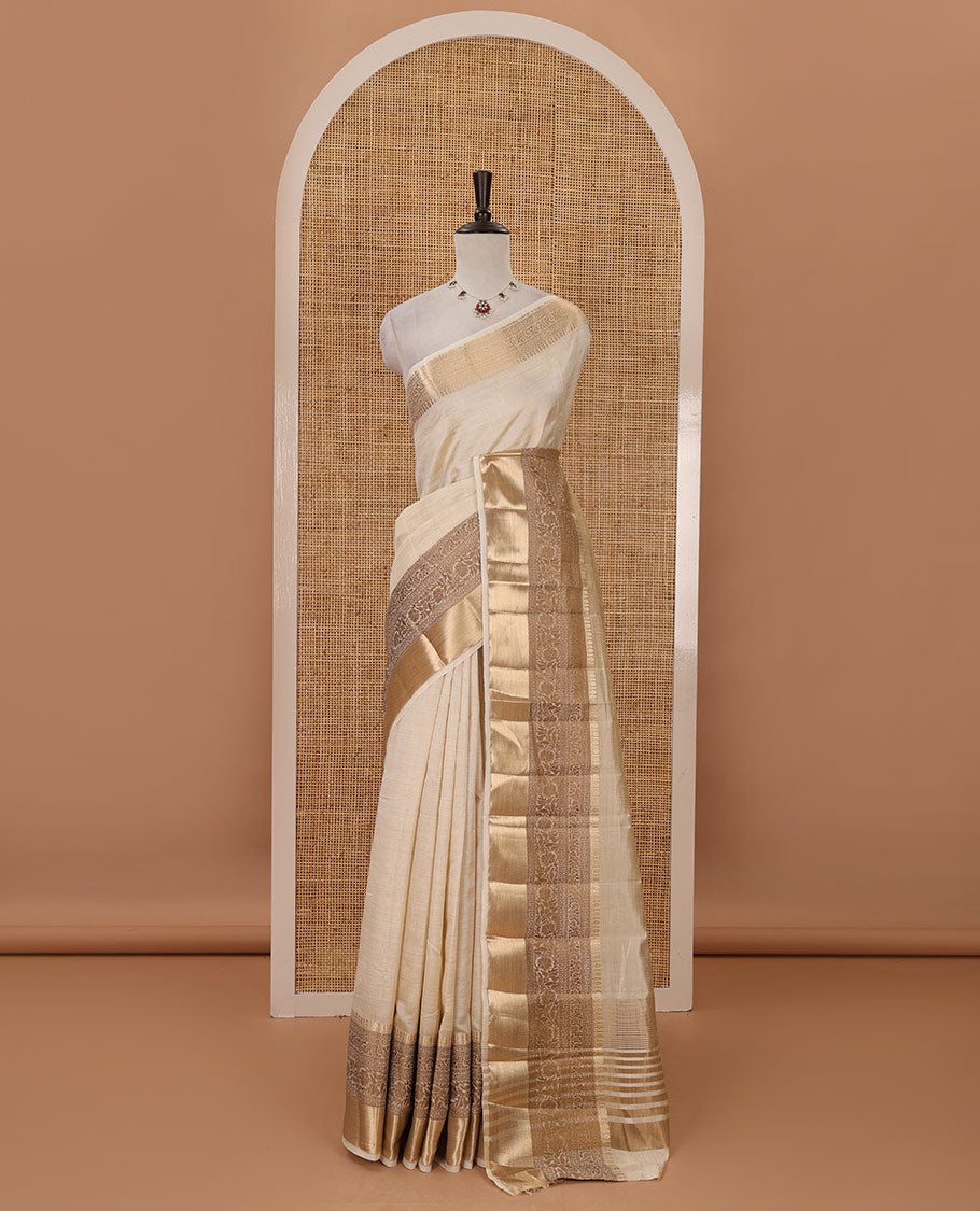 Cream plain tussar saree, traditional zari design border, pallu of zari stripes & matching traditional motif border blouse