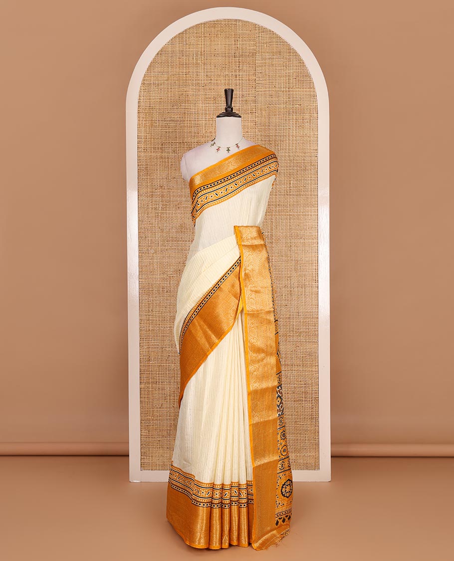 Cream-mustard zari striped dola silk saree, contrast traditional zari border of leaf creeper, Ajrakh printed pallu, and Ajrakh printed blouse
