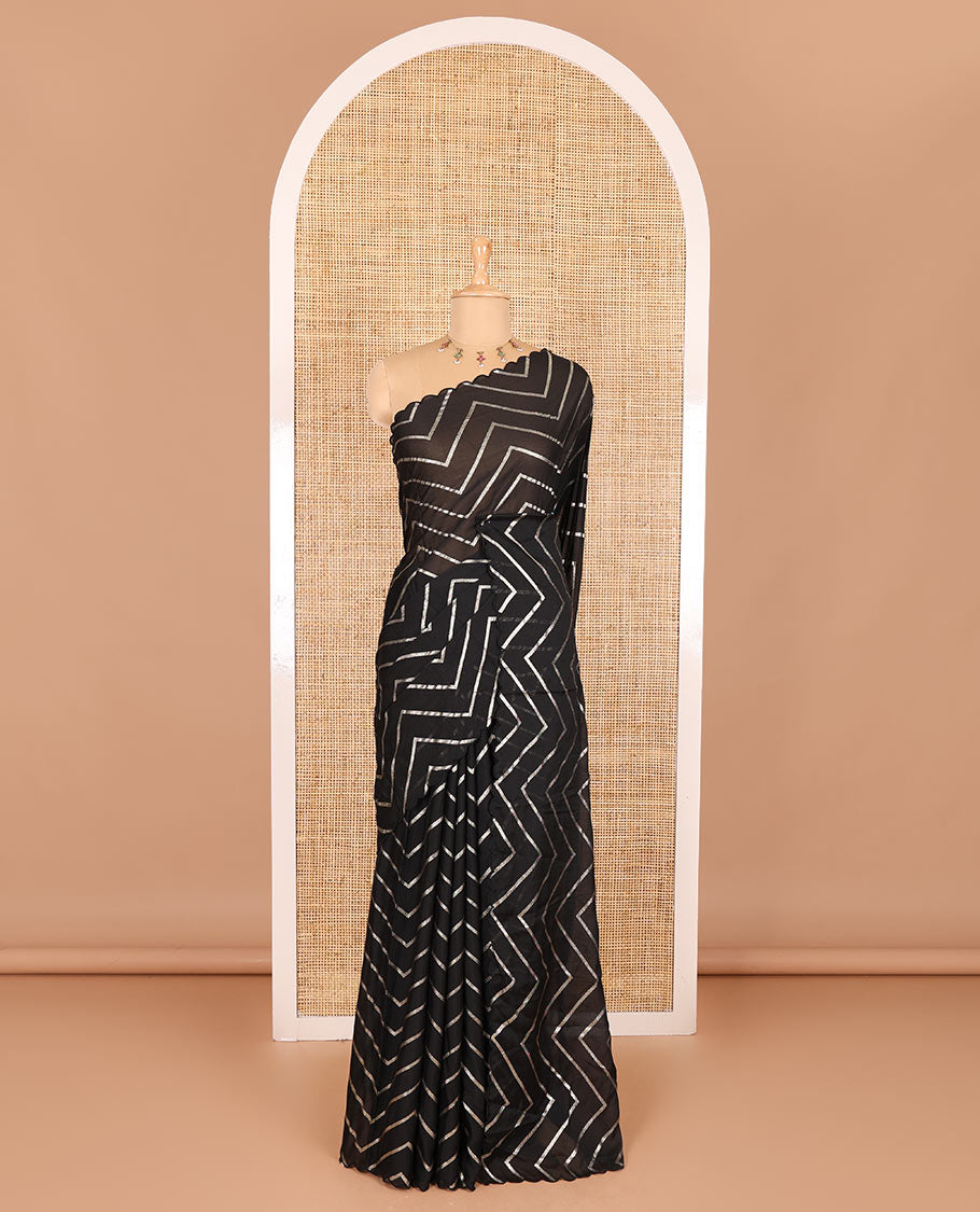 Borderless black zig-zag stripes gold foil printed, scallop-edged rangoli chiffon saree with a matching bandhani dotted blouse