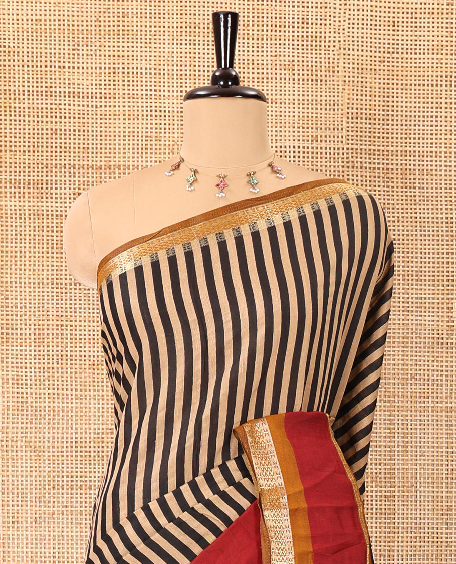 Black vertically striped muslin silk saree, contrast zari rettai pettu border, kalamkari floral vine printed pallu, and a contrast plain blouse