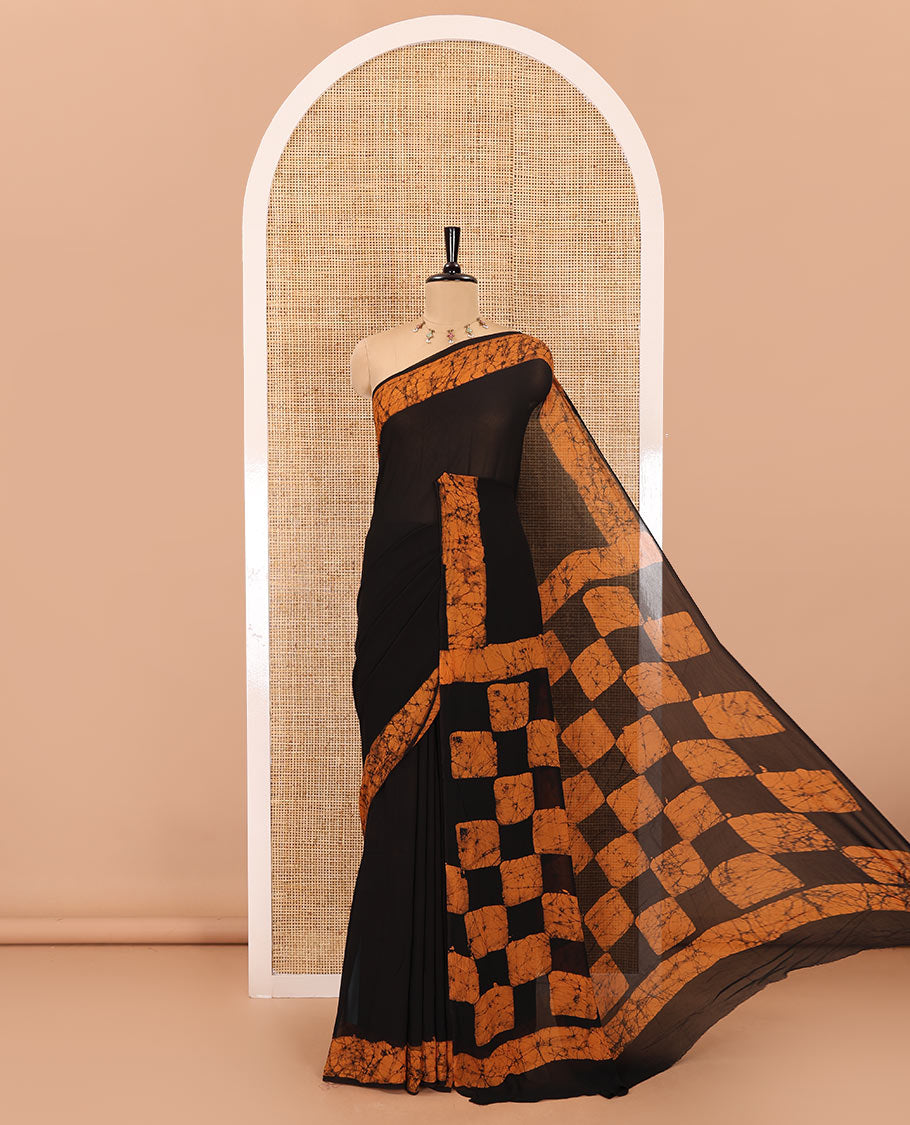 Black and mustard plain georgette saree, batik printed border, batik printed checked pallu, and a matching blouse