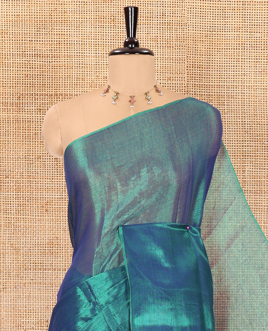 Borderless peacock green plain khadi tissue saree self pallu with tassels and a matching blouse