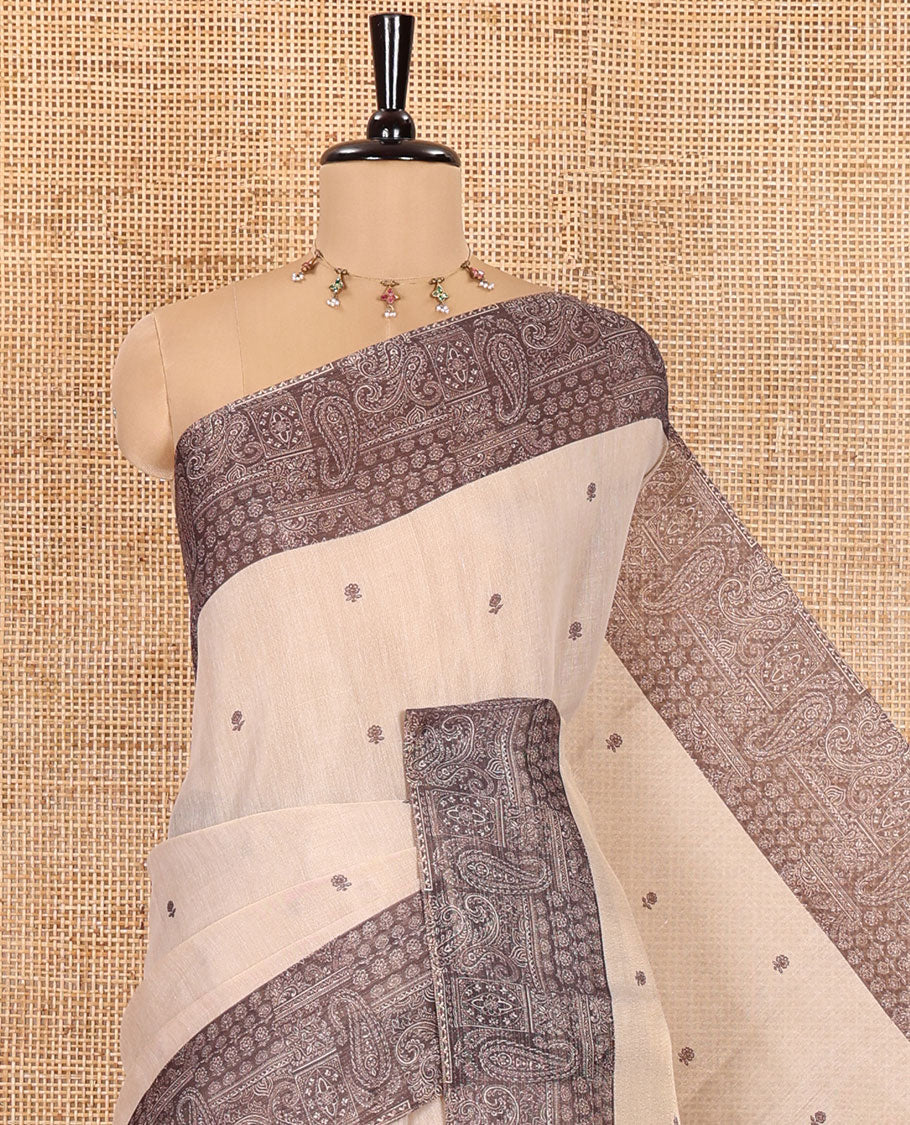 Chikku and Black Tissue Linen Saree, Delicately Printed with Floral Motifs on Its Body, Complemented by a Contrast Border of Paisley Designs, Pallu Steeped with Paisley Designs, and Paired with a Contrast Blouse
