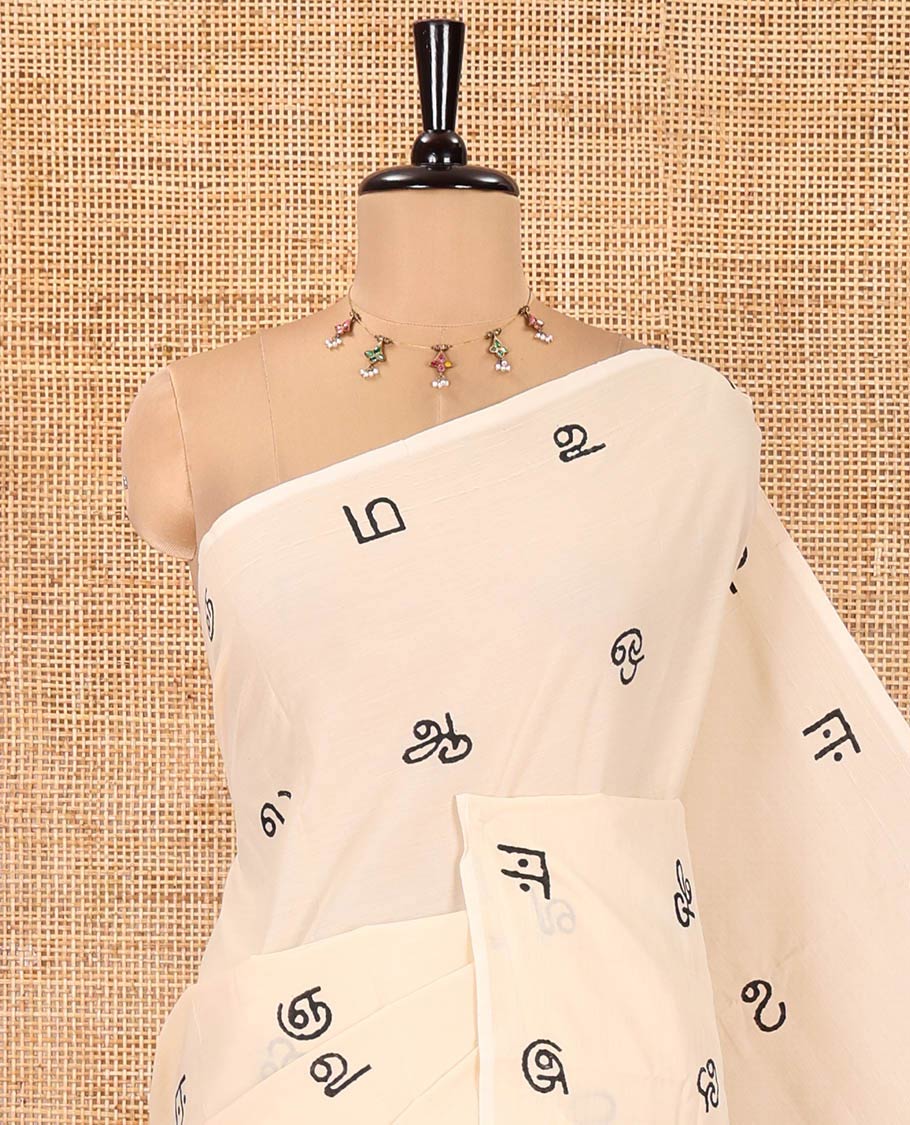 Borderless Cream South Cotton Saree, Elevated with Tamil Letters Printed on Its Body, a Self-Pallu, and Comes with a Matching Blouse, and a Contrast Printed Blouse
