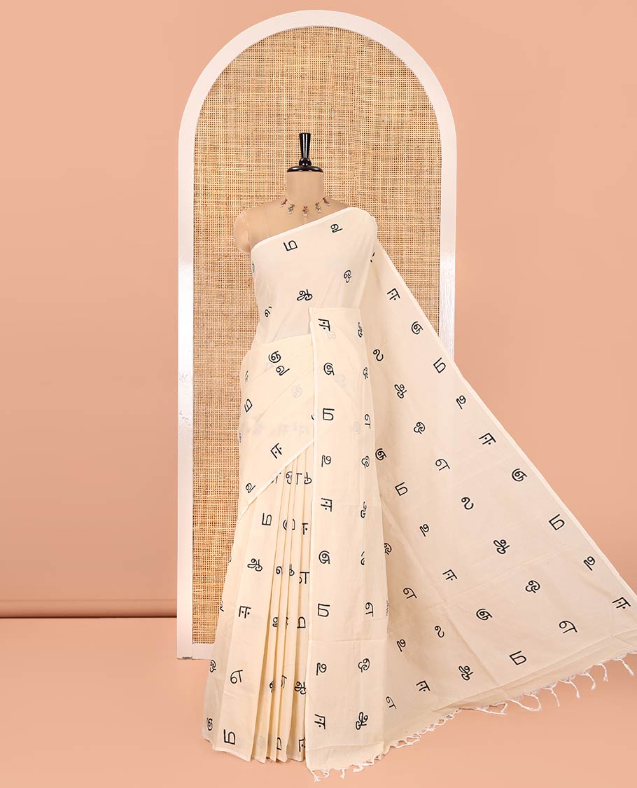 Borderless Cream South Cotton Saree, Elevated with Tamil Letters Printed on Its Body, a Self-Pallu, and Comes with a Matching Blouse, and a Contrast Printed Blouse