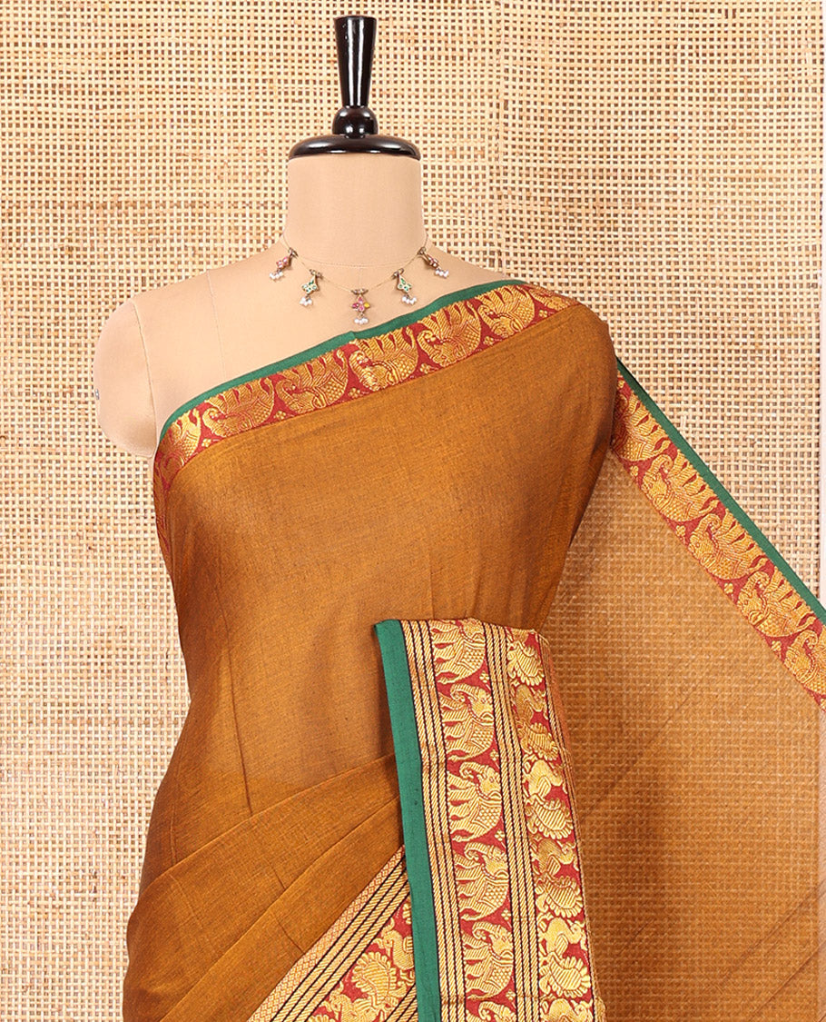 Mustard Plain Mercerised Cotton Saree, Complemented by a Contrast Traditional Border of Peacock, Elephant, and Peacock Eye Designs, Striped Pallu, and Paired with a Matching Blouse