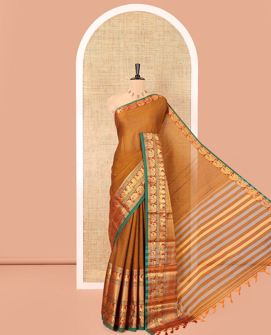 Mustard Plain Mercerised Cotton Saree, Complemented by a Contrast Traditional Border of Peacock, Elephant, and Peacock Eye Designs, Striped Pallu, and Paired with a Matching Blouse