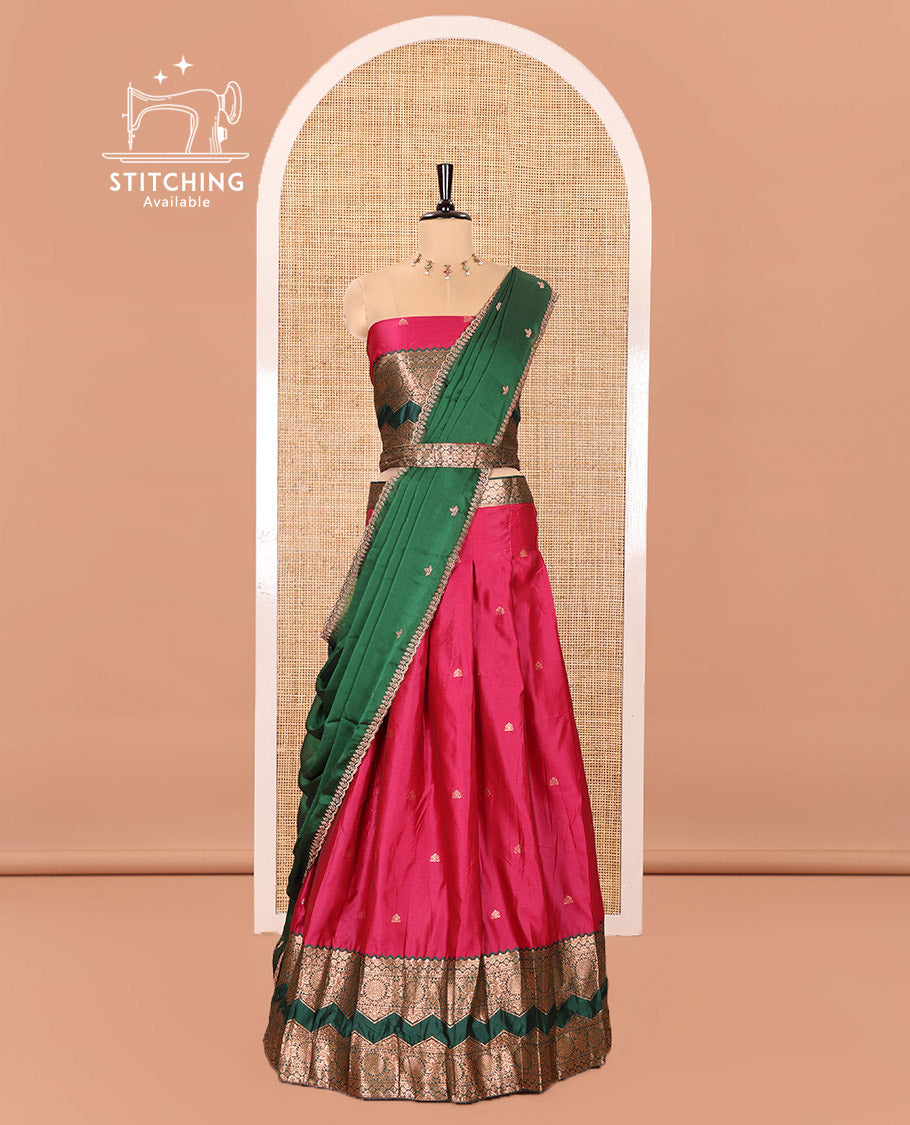 Pink and Green Semi-Banarasi Half-Saree Elevated with Zari Buttas on Its Skirt, Complemented by Contrast Traditional Zari Border of Chakram Designs, Paired with a Matching Blouse, and a Satin Georgette Embroidered Scallop Dhavani