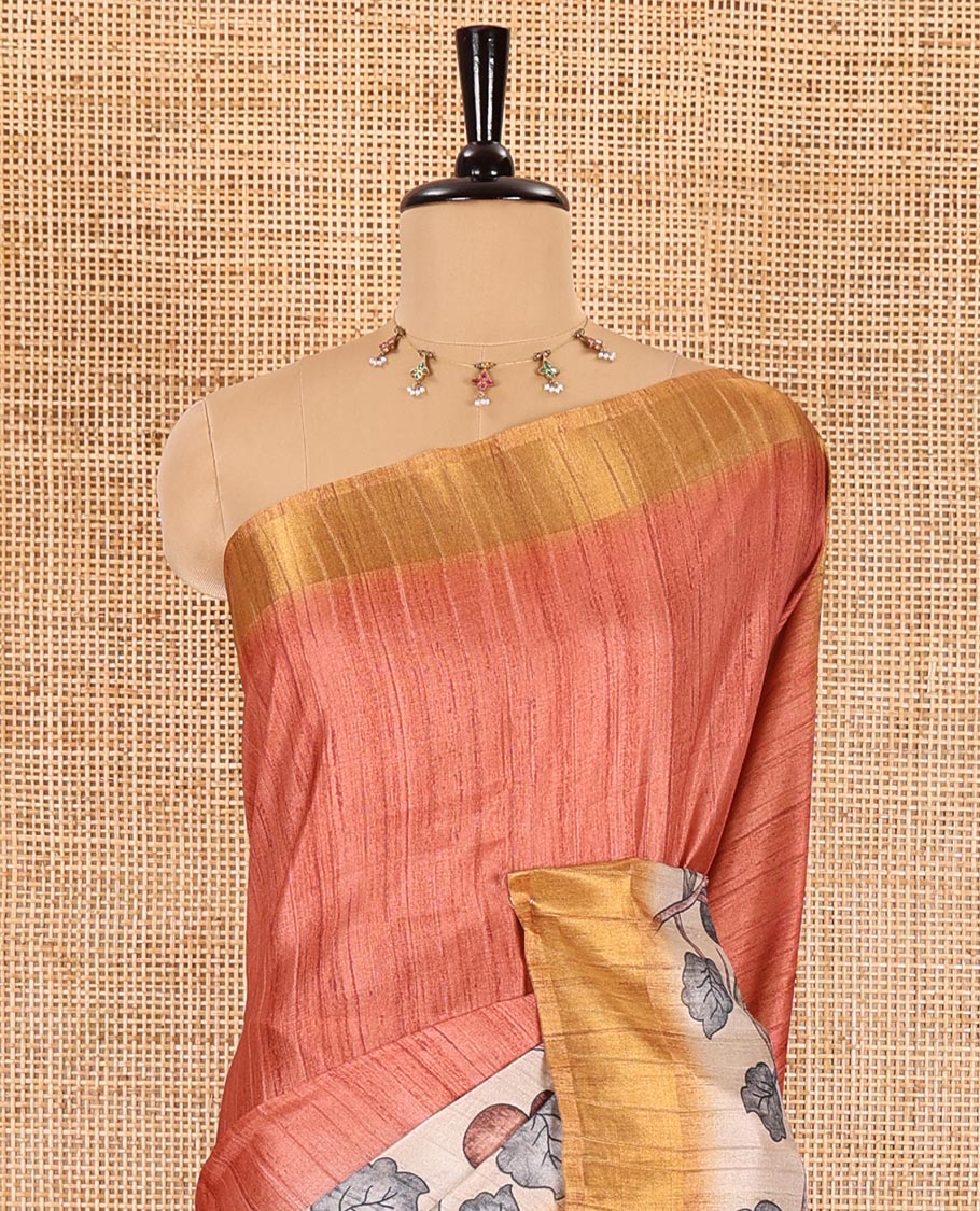 Orange plain fancy tussar saree, contrast floral printed border, floral vine printed pallu, and a contrast plain blouse