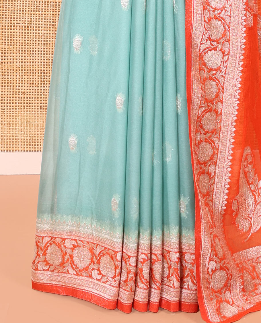 Turquoise Banaras Fancy Georgette Saree, Ornamented with Zari Buttas All Over Its Body, Complemented by a Contrast Floral Creeper Zari Border, Pallu Features Paisley Designs, and Paired with a Contrast Blouse