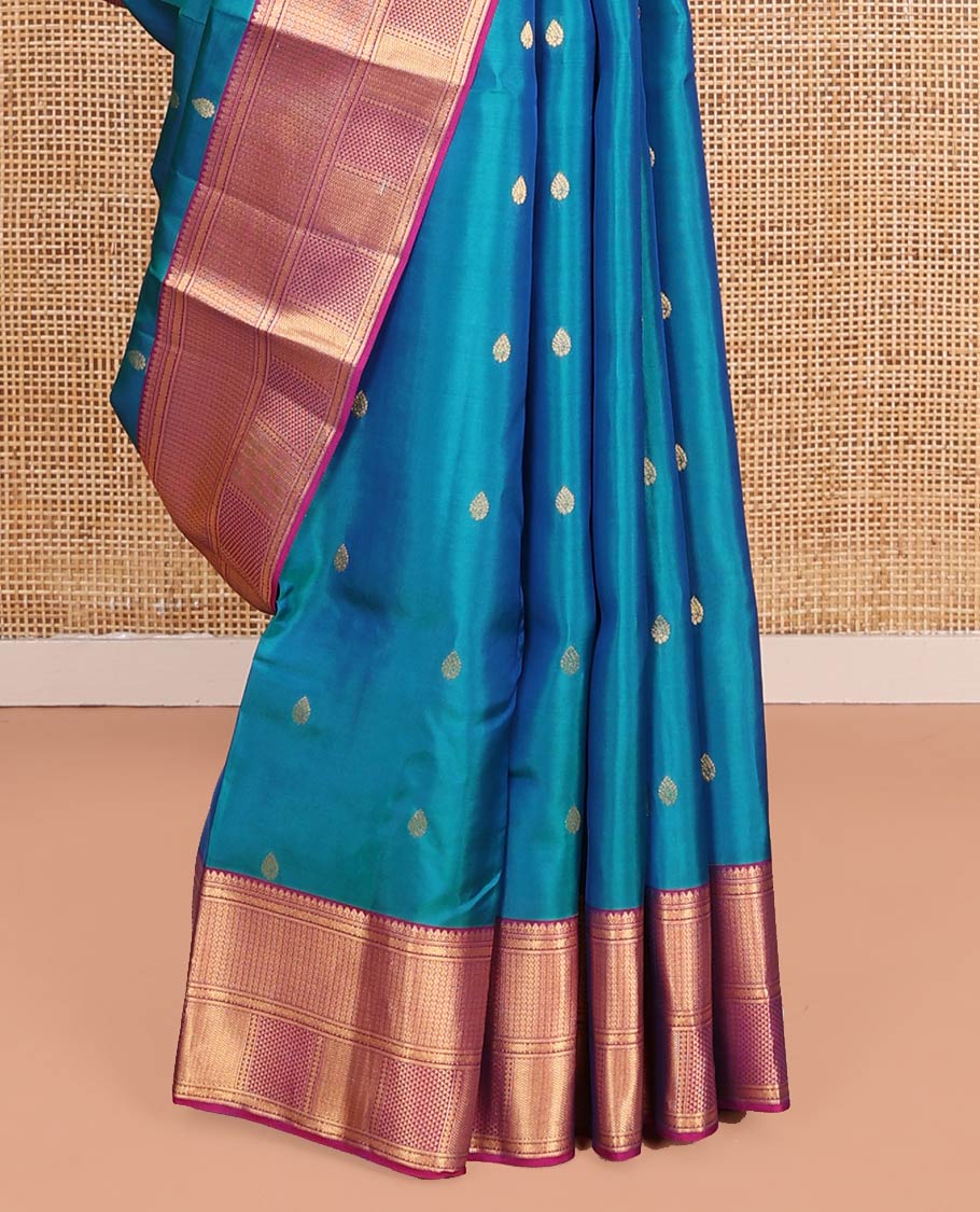 Blue Vasundhara Lite-Silk Mix Saree Highlighted with Zari Buttas on Its Body, Complemented by a Contrast Border of Thilakam Mokku, Ara Maadam, Vanki, and Then Kuli Kann Designs, Pallu Elevated with Jaal Designs, and Paired with a Contrast Blouse