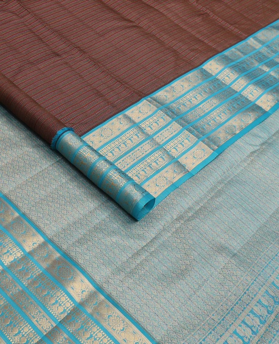 Brown striped Vasundhara silk mix saree, contrast border of muthu, paisa, and mayil designs, and jaal pallu