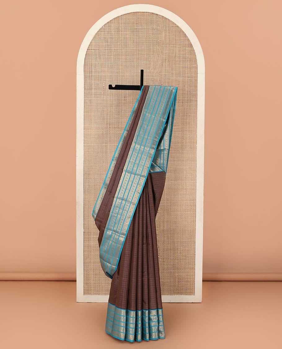 Brown striped Vasundhara silk mix saree, contrast border of muthu, paisa, and mayil designs, and jaal pallu